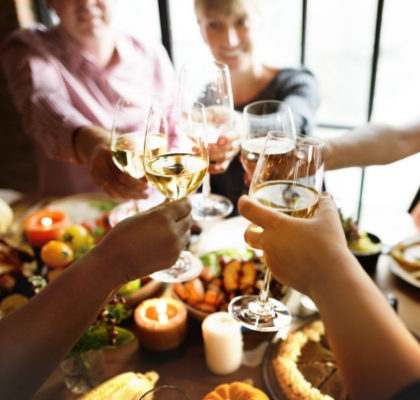Family enjoying Thanksgiving with glasses of wine